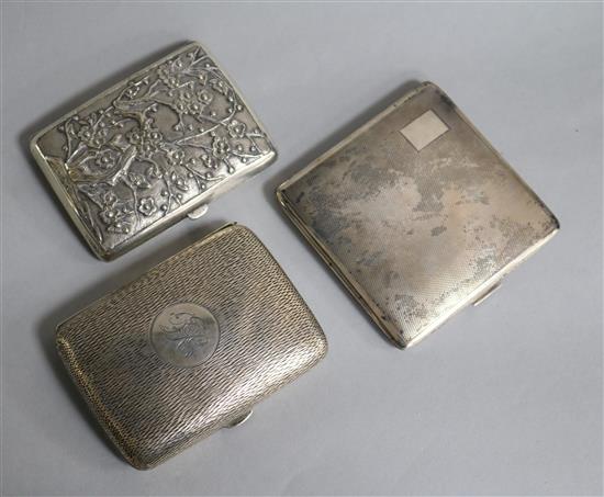 Two silver cigarette cases and a Chinese white metal cigarette case decorated with dragons and prunus, gross weight 8.8 oz.